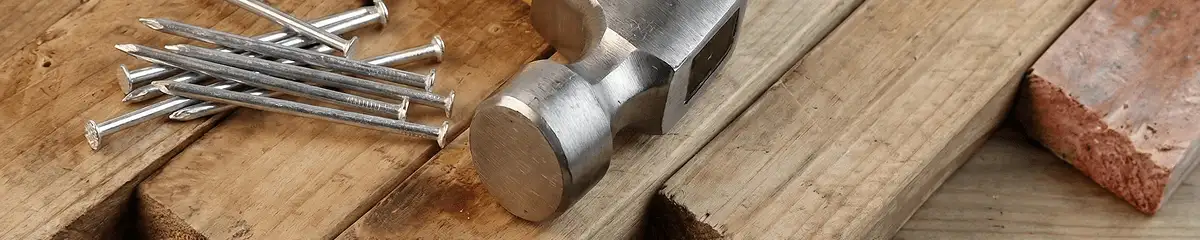 Hammer and nails on hardwood flooring boards in Reno, NV