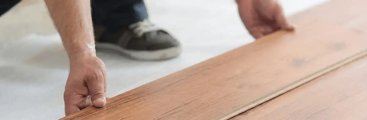 A professional installing laminate flooring in Reno, NV